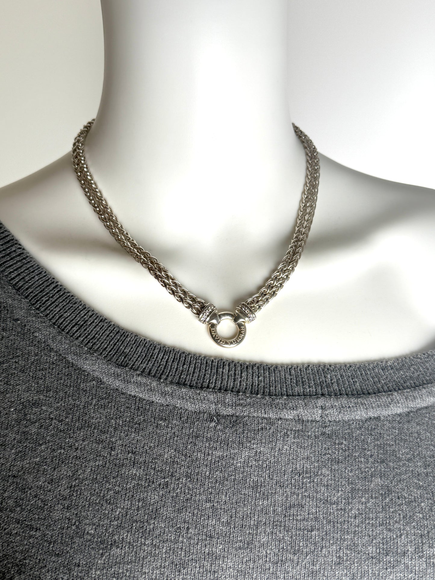 Designer: David Yurman
Length: 17”
Metal type: 925 sterling silver
Hallmark:  925, Designer signature
Item weight: 58g
Gemstone: 12 Diamonds, near colorless
Condition: Excellent. Light hairline scratches and discoloration at metal. Please see the photographs.
Inclusions: Pouch.
Retail price: $1350

Attach a DY Albion pendant to this necklace or wear it alone.  A classic piece of jewelry from David Yurman that will last for generations to come.

All items sold by Fashion Reloved are guaranteed authentic and 
