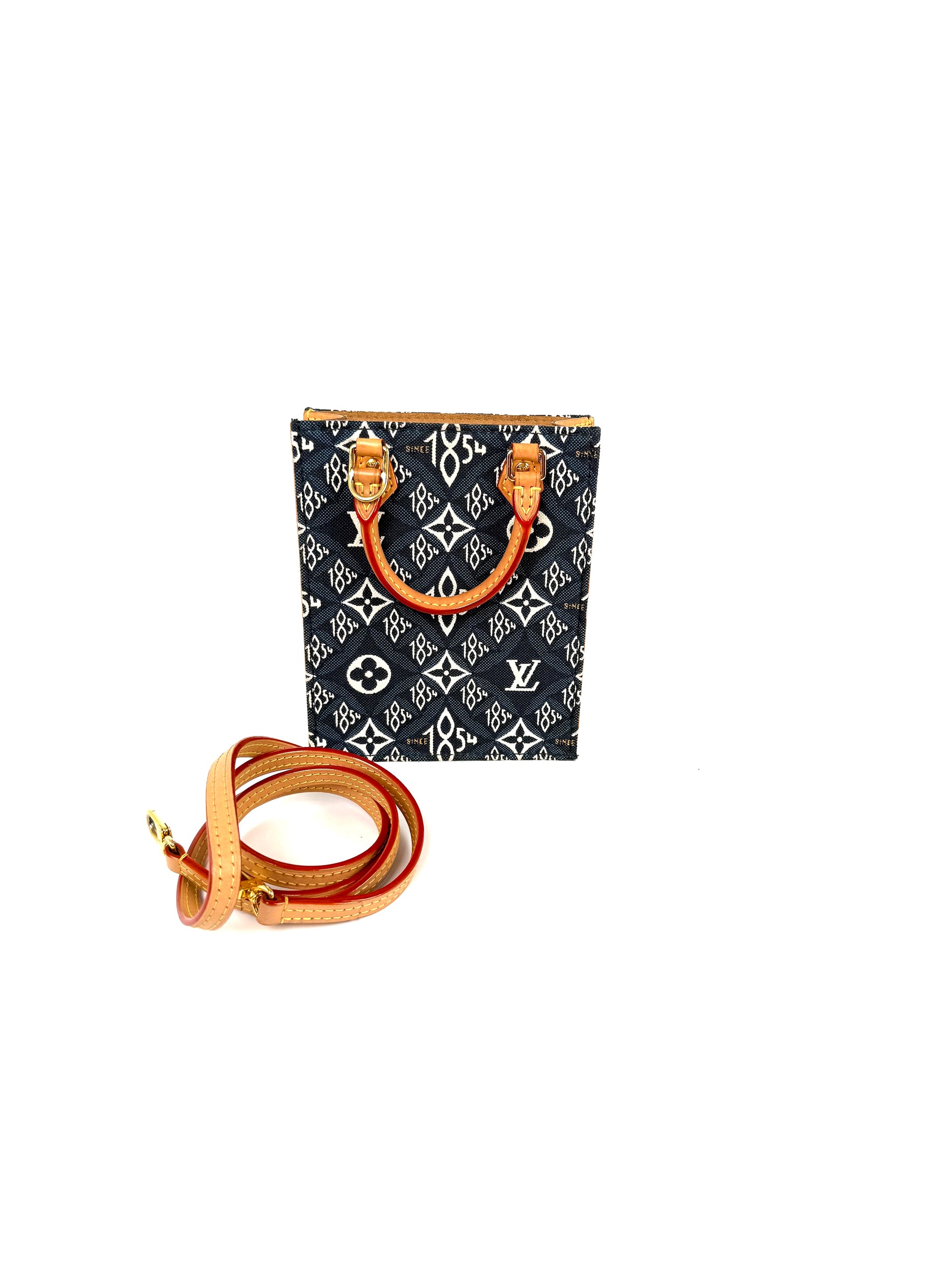 Louis Vuitton monogram canvas handbag with a black and white pattern, tan leather handles, and a matching coiled tan leather shoulder strap on a white background.