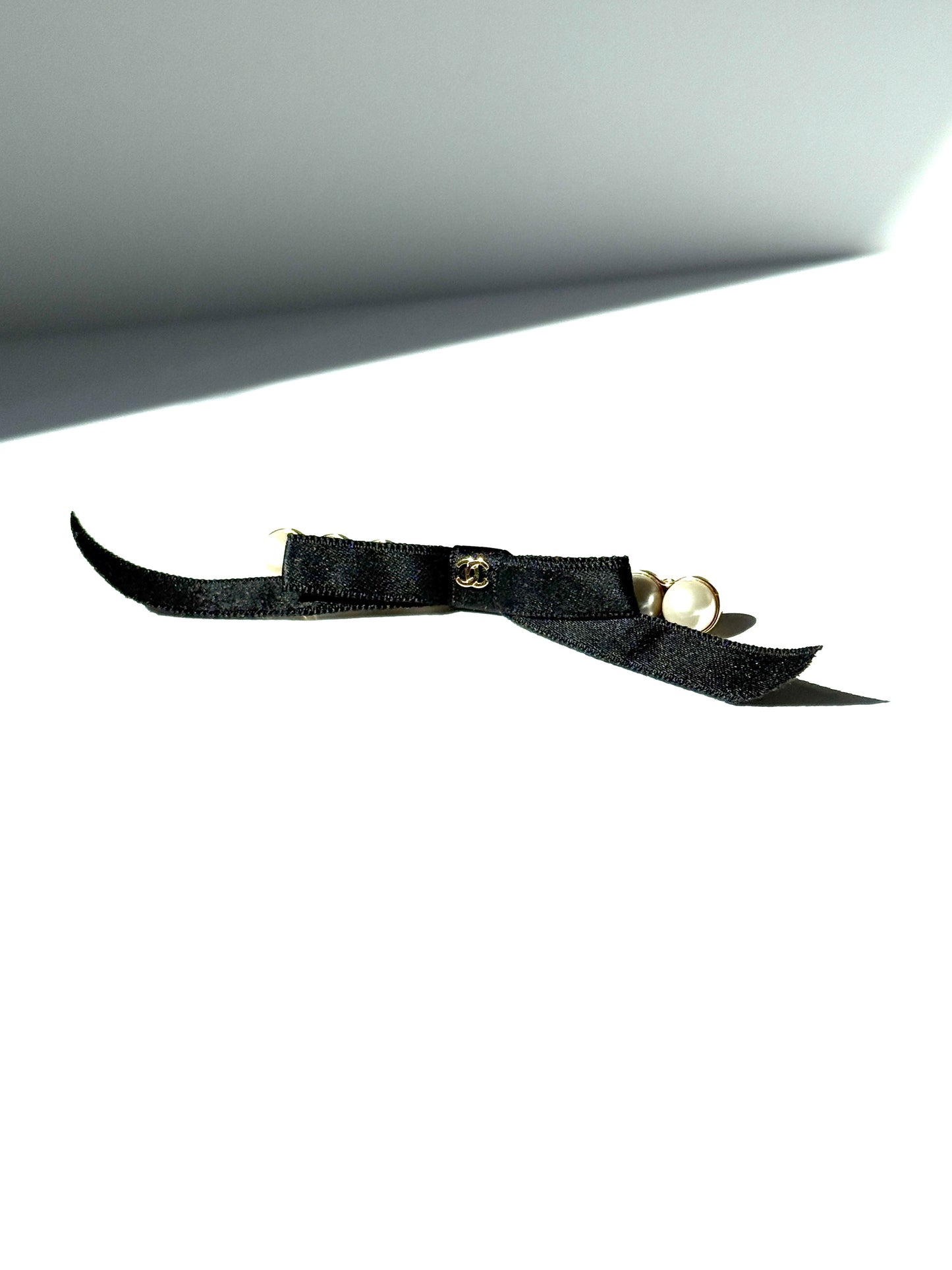 CHANEL Black Faux Pearl Bow CC Logo 2025 Gold hardware Hair Barrette Clip 